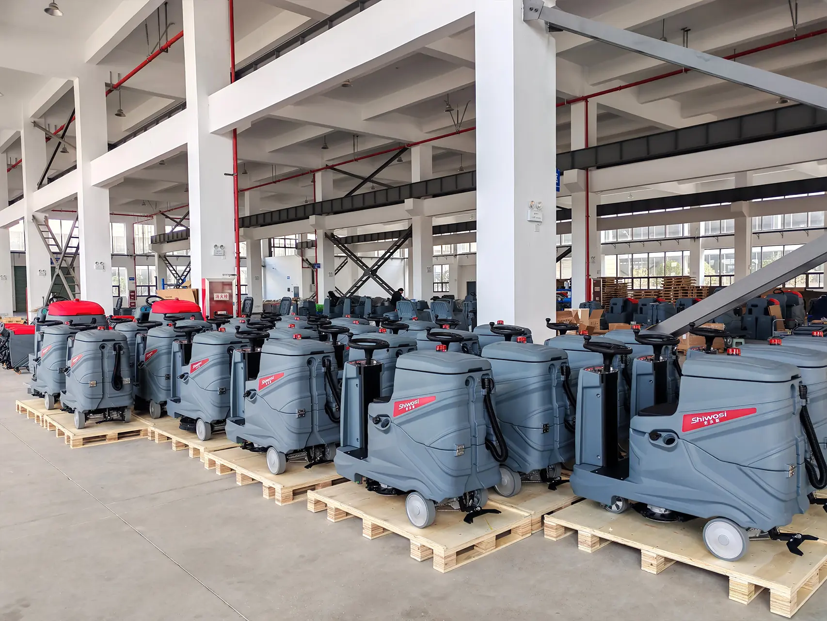 Floor scrubbers lined up in the factory